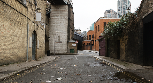 Dirty city street before professional power sweeping services