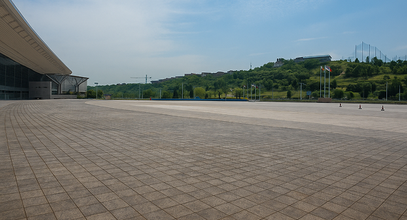 A dirty commercial lot before pressure washing