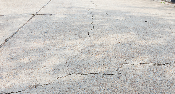 Cracked asphalt before repair