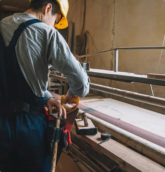 Profesional carpenter at work performing carpentry services.