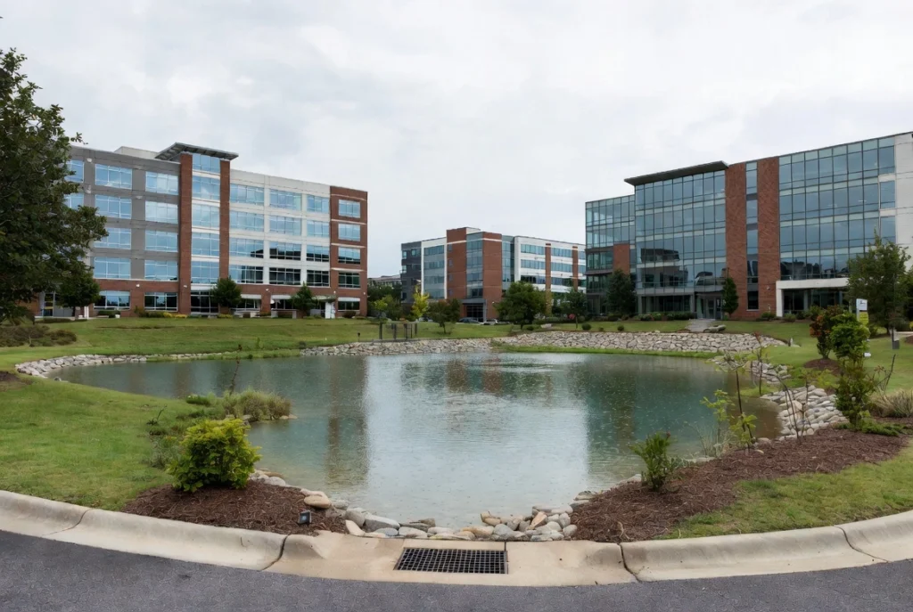 Modern office buildings with a scenic retention pond in a business park