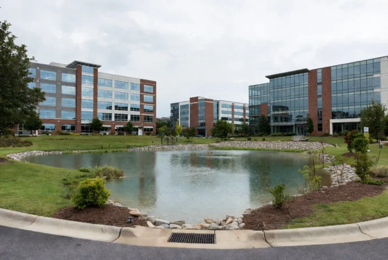 Modern office buildings with a scenic retention pond in a business park